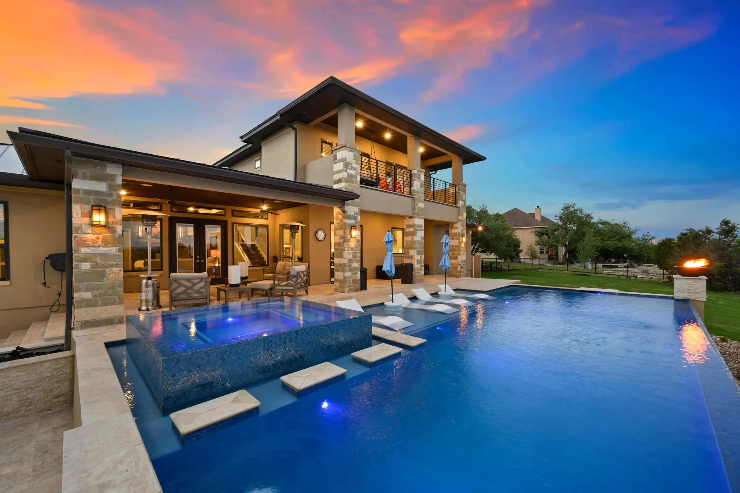 Custom gunite pool and spa at sunset built by a luxury pool builder on the Texas Gulf Coast